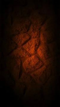 Dark grainy stone wall with a soft orange glow at the center, creating a wa.. Stock Photos