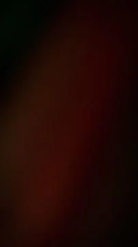 Dark grainy vertical background with shades of black red and brown for tech.. 스톡 사진