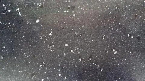 Dark granite stone surface covered with small scattered water droplets Stock-Fotos