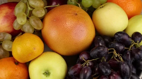 Dark grapes, grapefruit, apples, orange Stock Footage 124193478