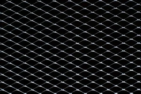 Dark gray and silver grid of metal fence that taking as background. Stock Photos