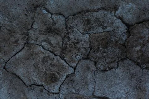 Dark gray background with cracks and hollows Stock Photos