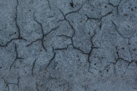 Dark gray background with cracks and hollows Stock Photos