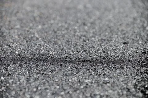 Dark gray background created with a blurred asphalt road. Stock Photos