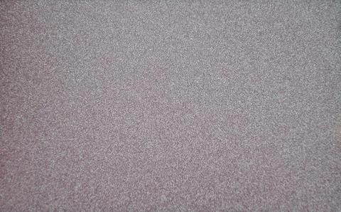 Dark gray background with glitter all over, vignetting and background blur. Stock Photos