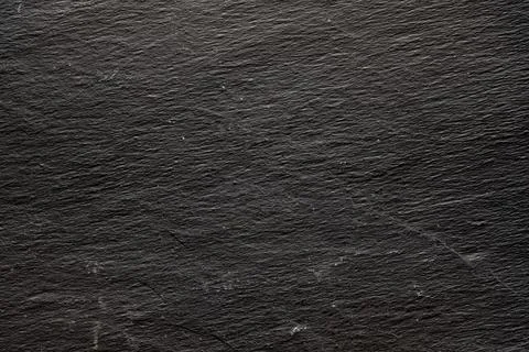 Dark gray black slate background or natural stone texture. Black board for se Stock Photos