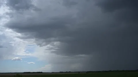 Dark gray-blue storm cloud with rain falling moves towards the viewer  Stock Footage 155352622