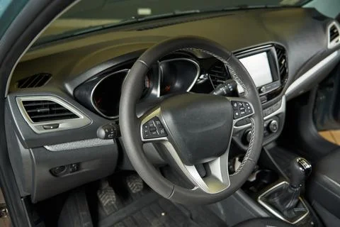 Dark gray car interior with light inserts. dashboard, controls, deflectors Stock Photos