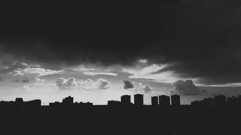 Dark gray clouds cover a gloomy city. It's starting to rain Stock Footage 93031995