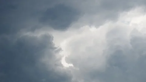 Dark gray clouds roll in as the storm approaches the area. The atmosphere feels Stock Footage 335536302