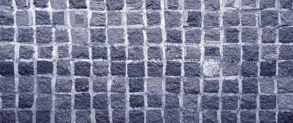Dark gray cobblestone wall texture background with square stone block grid .. Stock Photos