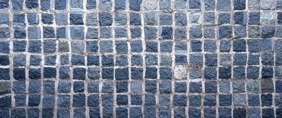 Dark gray cobblestone wall texture background with square stone block grid .. Stock Photos