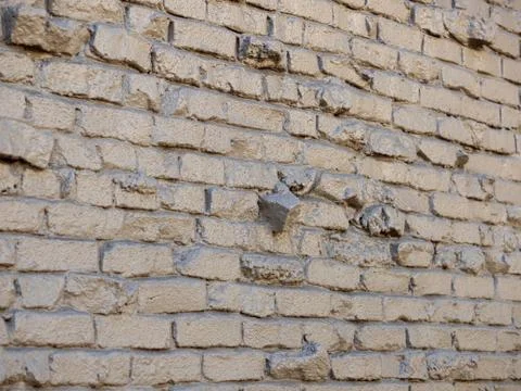 Dark gray covered brick wall with light reflecting off out doors Stock Photos