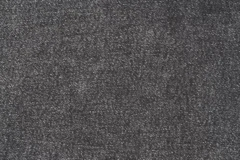 Dark gray denim fabric texture closeup. Black twill weave material background Fotos de archivo