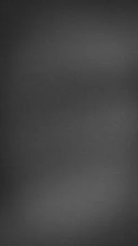 Dark gray grainy abstract vertical background with subtle blur and gradient.. Stock Photos