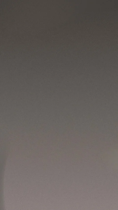 Dark gray grainy texture with subtle color variation. Seamless loop background. Stockbeeldmateriaal 309957124