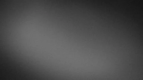 Dark gray grainy textured background with subtle gradient blur suitable for.. Stock Photos