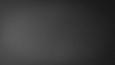 Dark gray grainy textured background with black gradient blur perfect for a.. Stock Photos