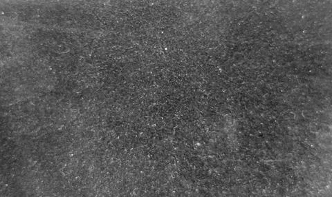 Dark gray grunge texture with rough stone surface and dusty appearance Stock Photos