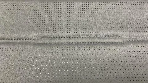 Dark gray perforated artificial leather background texture Stock Photos