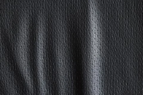Dark gray perforated leather texture background with subtle wrinkles and smal Stock Photos