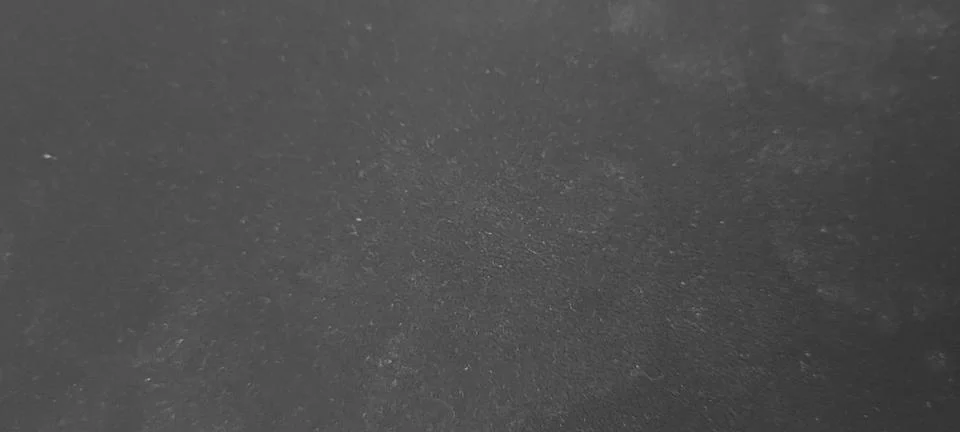 Dark gray plaster wall texture with a smooth matte finish and subtle surfac.. Stock Photos