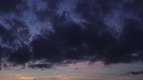 Dark gray rain clouds floating in time lapse on summer evening twilight sunset Stock Footage 163185559