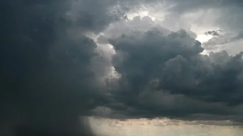 Dark gray rain clouds moving across a yellowish stormy sky. Heavy rain falling Stock Footage 256242758