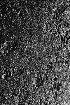 Dark gray stone wall texture with rough grainy surface Stock Photos