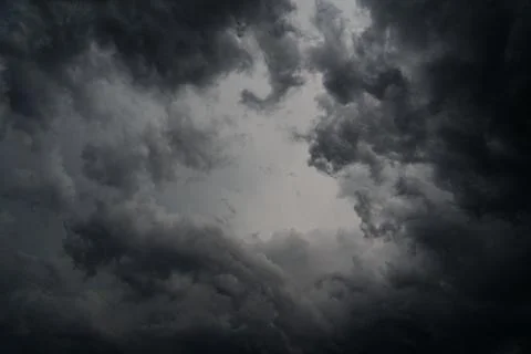 Dark gray storm clouds before rain. Bad weather, darkness, death. Stock Photos