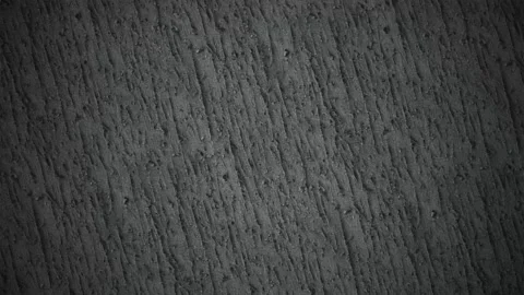 Dark gray stucco wall texture with subtle motion and grainy surface detail Video stock 341603851