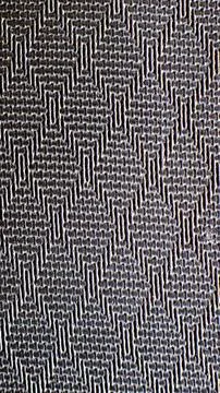 Dark gray textile with zigzag pattern Stock Photos
