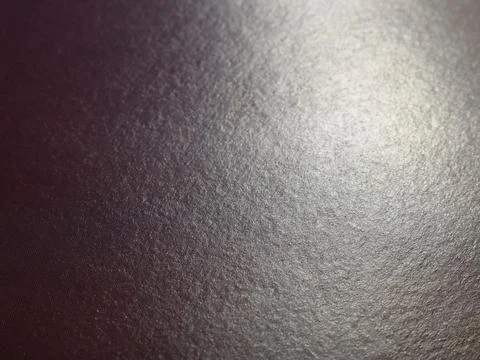 Dark gray texture with a spot of light on a glossy surface Stock Photos
