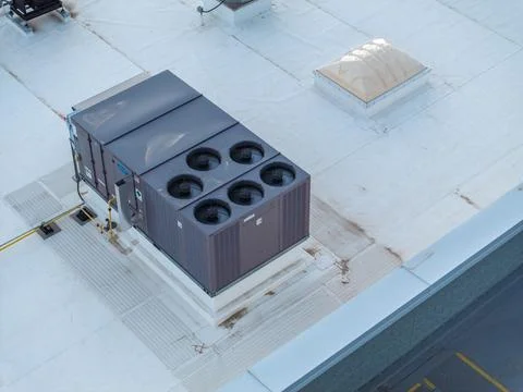 Dark gray unit with circular vents sits on concrete platform 库存照片