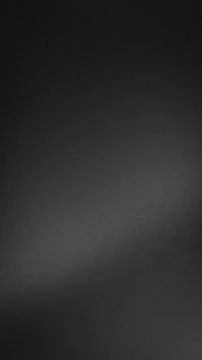 Dark grayscale grainy texture background vertical format with abstract blur.. Stock Photos