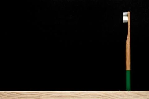 Dark green bamboo toothbrush on slate background. Foto stock