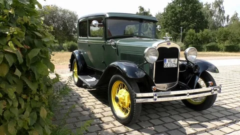 Dark green Ford Model A with yellow tires, chrome parts, oldtimer, historic car Video stock 114439044