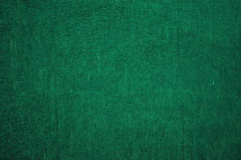 Dark green matte background, embossed textured wall. Stock Photos
