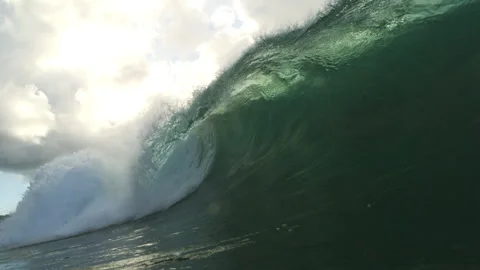 Dark Green Ocean Wave Curling Beneath Bright Clouds Near Water Level Stock Footage 344383111