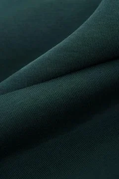 Dark green textile texture. Dense premium fabric. Cotton. Stock Photos