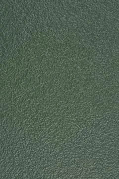 Dark green textured plastic surface in a vertical full frame background Stock Photos