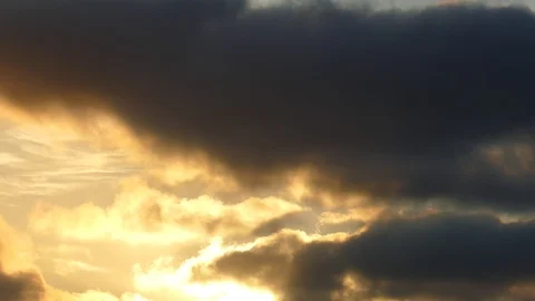 Dark grey and golden clouds at sunrise - 4k Real Time Video Stock Footage 107875195