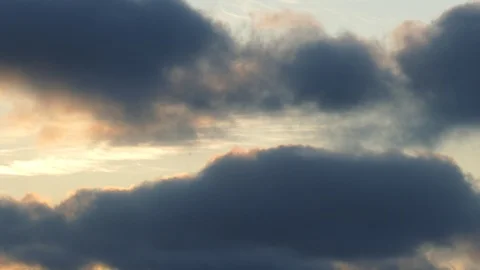 Dark grey and golden clouds at sunrise - 4k Real Time Video Stock Footage 107875769
