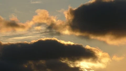 Dark grey and golden clouds at sunrise - 4k Real Time Video Stock Footage 107907929
