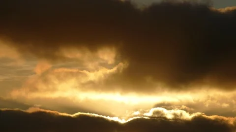 Dark grey and golden clouds at sunrise - 4k Real Time Video for background Stock Footage 107911121