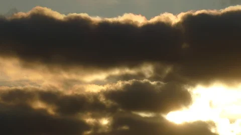 Dark grey and golden clouds with morning sun at sunrise - 4k Real Time Video 스톡 동영상 107952887