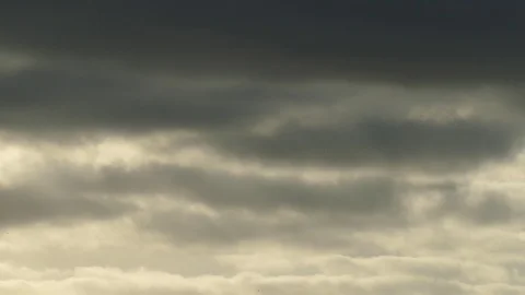 Dark grey and golden clouds at sunrise - 4k Real Time Video for background Stock Footage 108085806