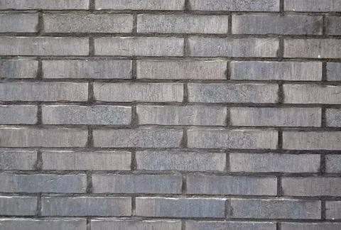 Dark grey brick wall. Abstract background or backdrop Stock-Fotos