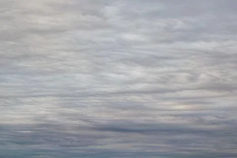 Dark, grey clouds covered the sky. Clouds in the form of lines and wavy layer Stock Photos