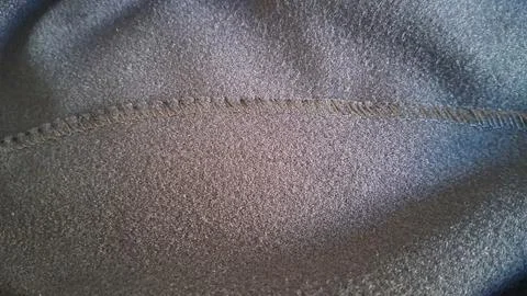 Dark grey fabric texture background. Close up of soft textile material with Stock Photos